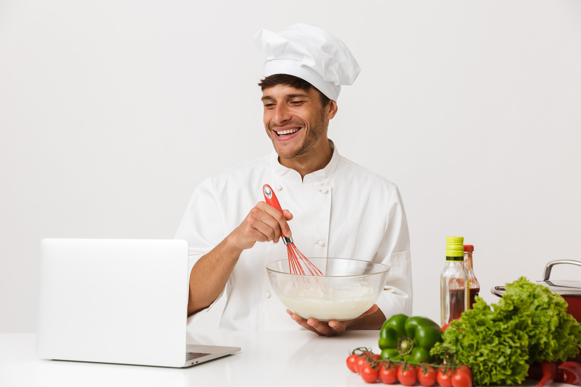 Founder chef smiling while teaching in a home kitchen